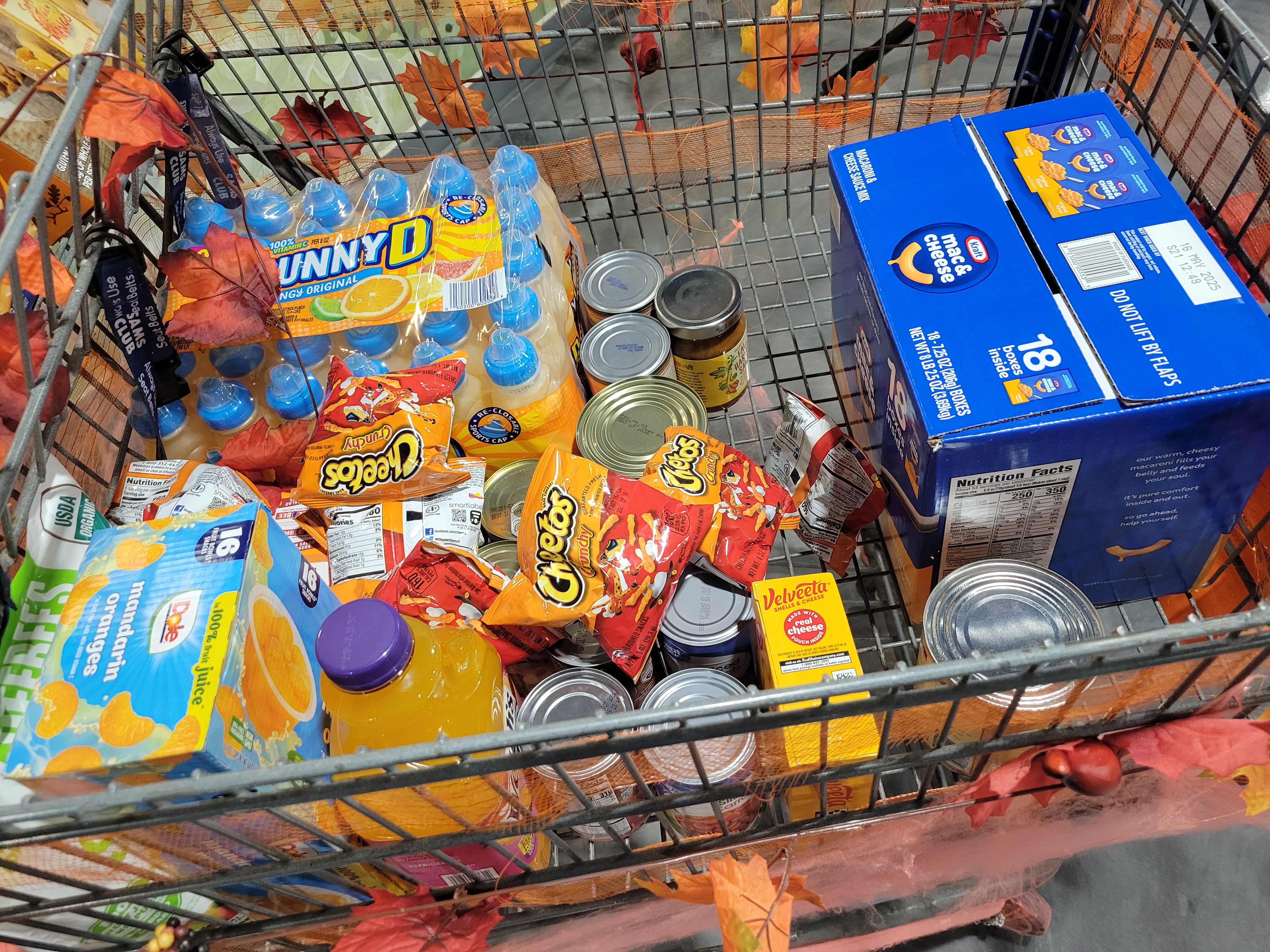 Big shopping cart full of orange-ish foods.